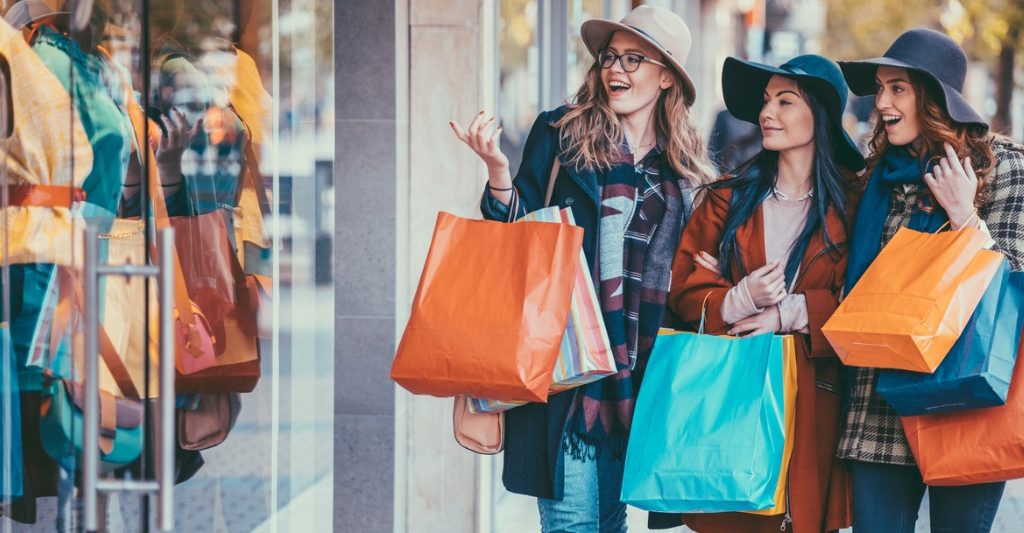 Women standing on sidewalk during a retail weekend